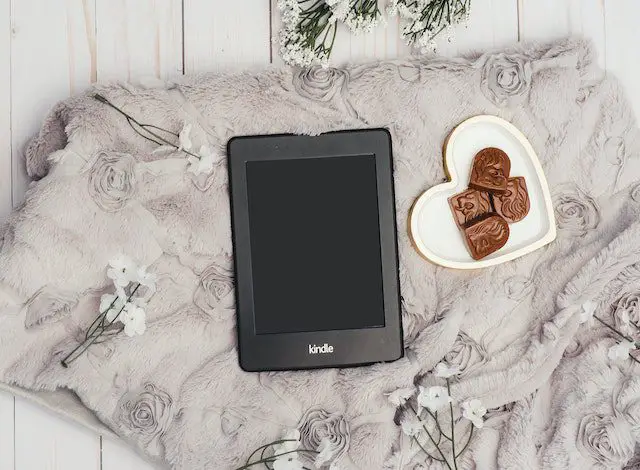 photo of black kindle tablet beside bowl of choclates