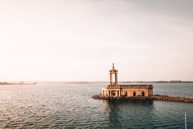 a building with a rooftop balcony built on the breakwater