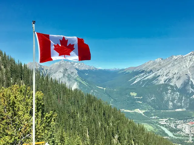 Canada-flag-with-mountain-range-view