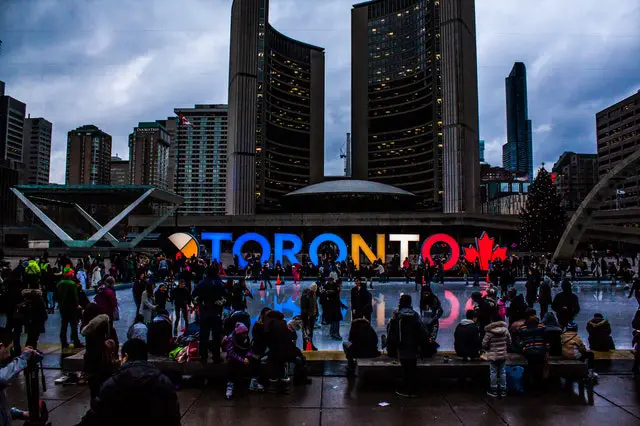 people-gathered-in-front-of-toronto-freestanding-signage