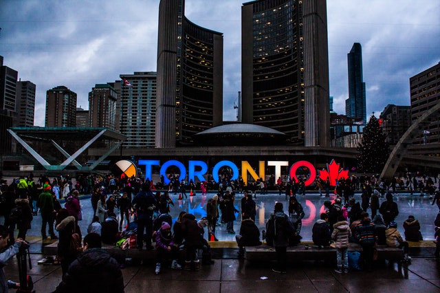 people-gathered-in-front-of-toronto-freestanding-signage