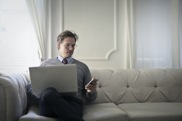 pexels-a man using laptop and phone