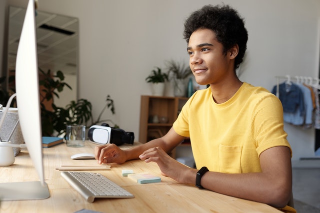 pexels-boy wearing yellow shirt while using a desktop