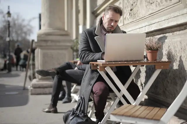 pexels-man in black using macbook