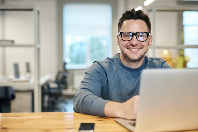 pexels-man-wearing-glasses-and-smiling