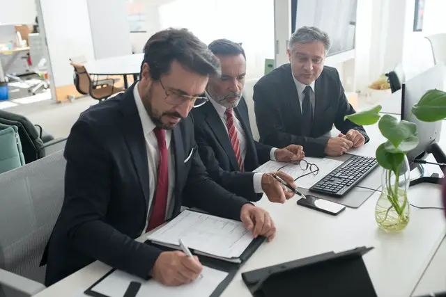 3 men in a office