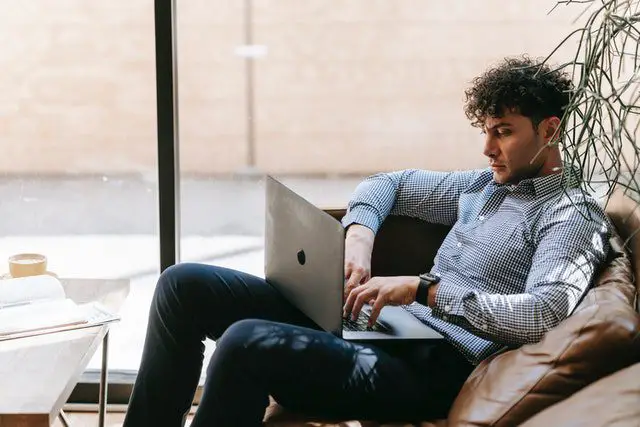 Pexels - A Man Using a Laptop while Sitting on a Couch