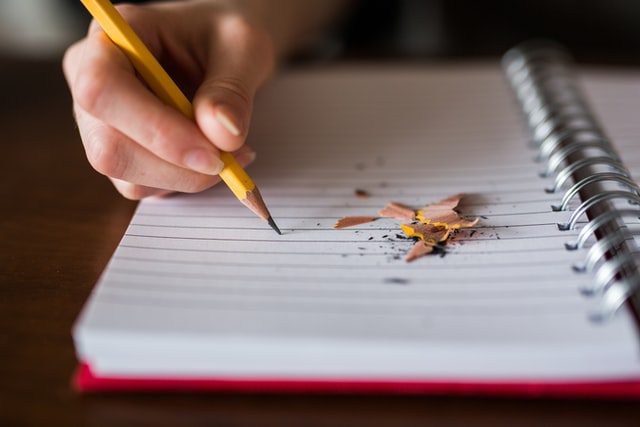 Writing on a book with pencil