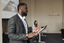 Pexels- A bearded man talking inside a conference room