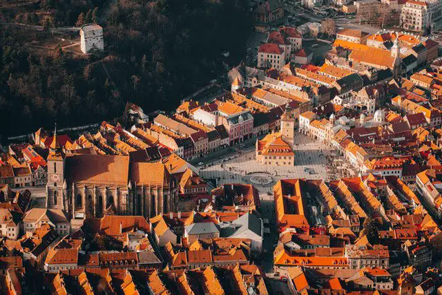 Pexels - An Aerial View of Casa Sfatului Surrounded by City Buildings in Brasov, Romania