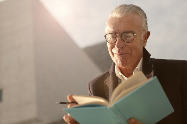 Pexels - Man in Black Suit Reading