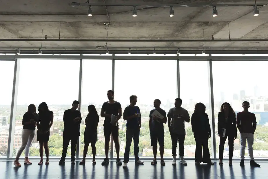 Shopify - large-group-standing-in-office