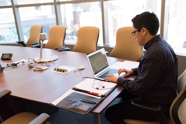 A man in front of a computer