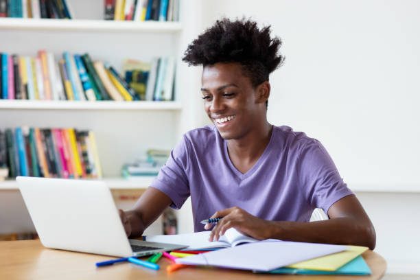 African Student in front of a laptop