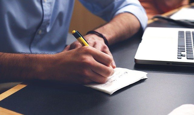 Pixabay - A man writing on a desk