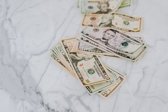 Pexels - dollar bills on marble