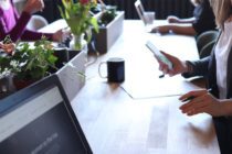 Pexels - Person holding smartphone in front of table