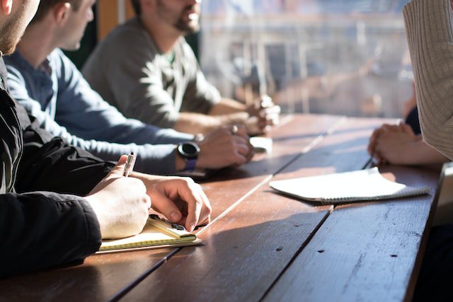 Unsplash - men discusing over a table