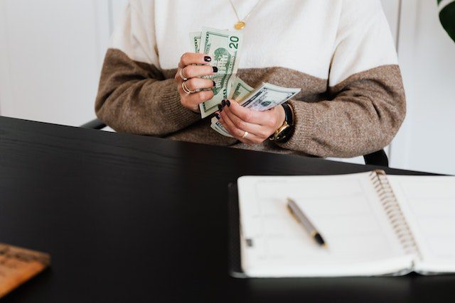 A-person-in-Sweater-counting-money