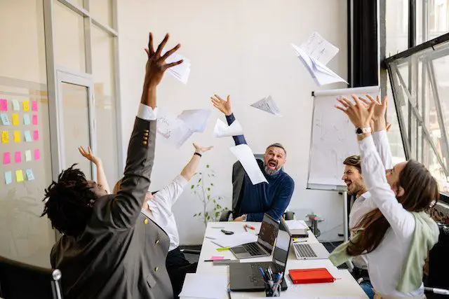 Pexels - Group of people at work throwing papers