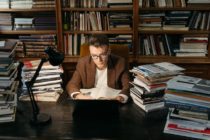 Man with books on table