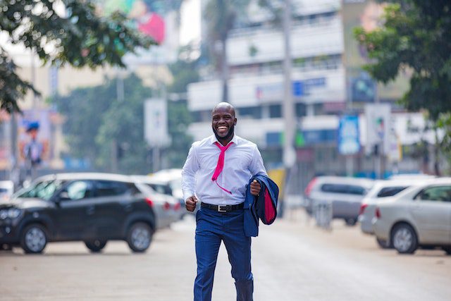 Happy man in suit standing in the street
