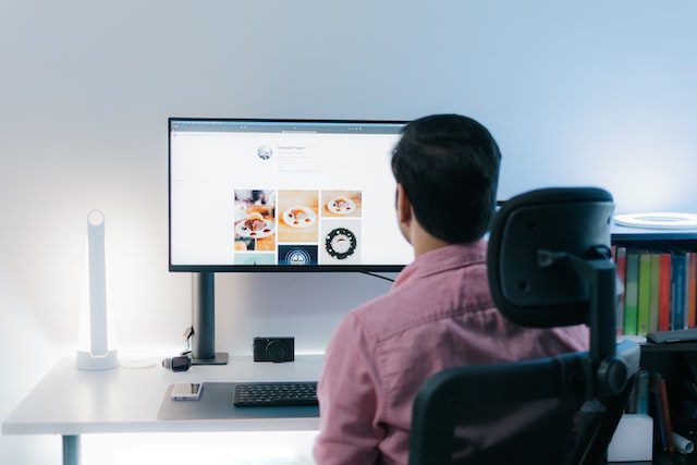 Unsplash - Man sitting in front of computer screen