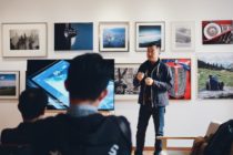 Pexels - Man Beside Flat Screen Television With Photos Background