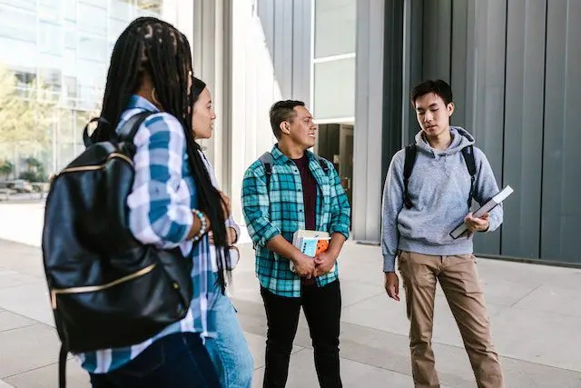 Pexels - Man in Blue Dress Shirt Standing Beside Woman in Gray Sweater