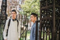 Pexels - Multiethnic students standing near gates of university building