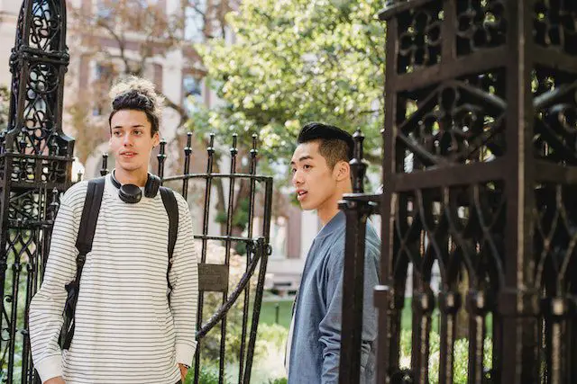 Pexels - Multiethnic students standing near gates of university building