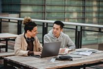 Young diverse men discussing homework in campus