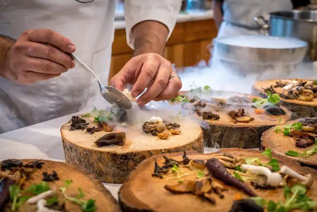 hef Preparing Vegetable Dish on Tree Slab