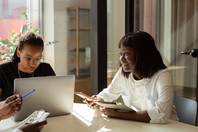 Female Colleagues sitting beside each other