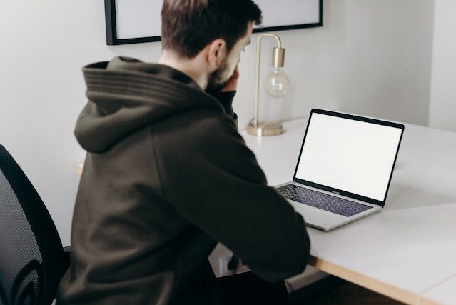 Pexels - Man in black jacket sitting in front of MacBook pro