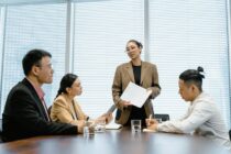 Pexels - Woman Standing Up in Front of Colleagues During Meeting