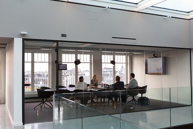 Unsplash - A group of colleagues having a business meeting in an office meeting room