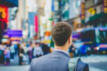 Unsplash - A man standing at the bustling Times Square