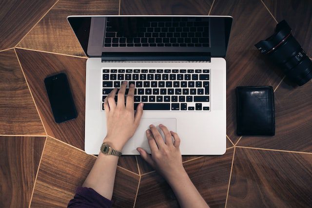 Hands on a laptop keyboard