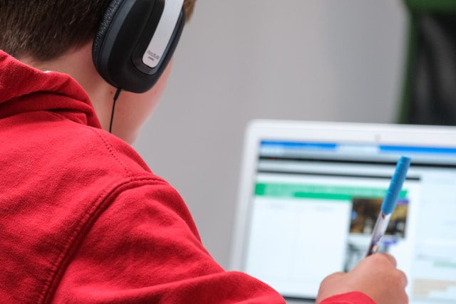 Unsplash - boy working on school work with laptop and headphones