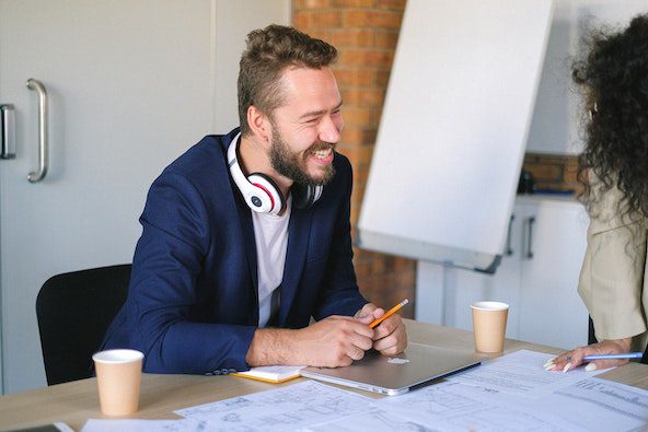 Pexels - Cheerful man working in office