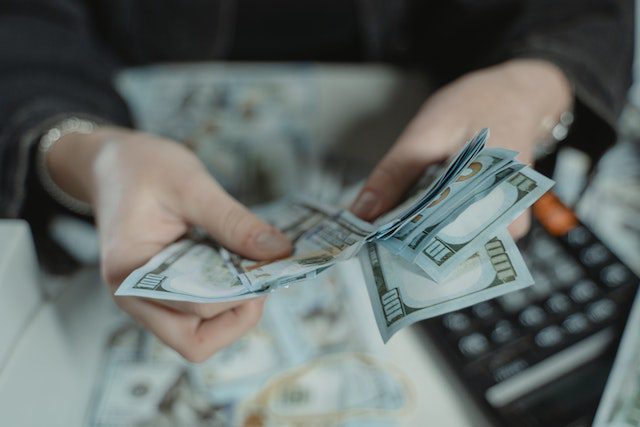 Pexels - Close up photo of a person counting bank notes