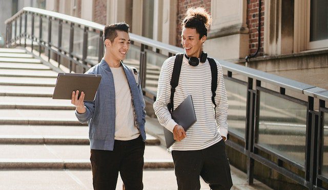 Multiethnic students walking along stairway in campus