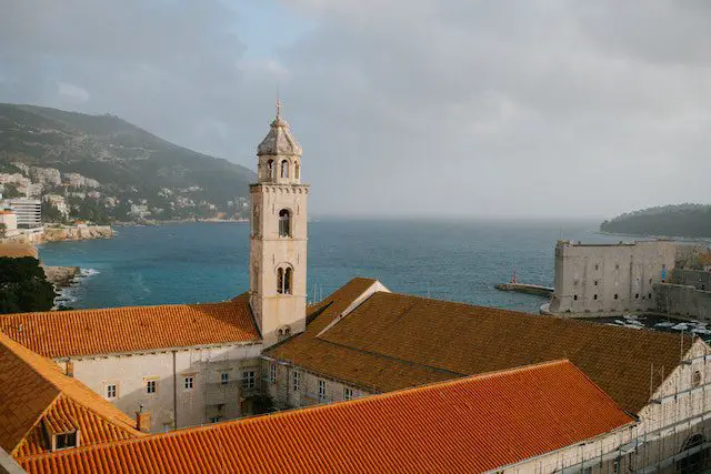 Tower on city building against sea