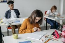 Pexles- student sitting at her desk