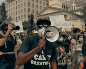 A man holds a megaphone at a protest