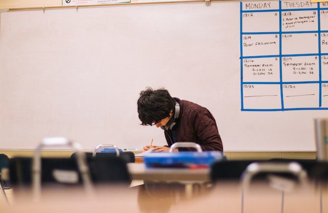 Man Writing on Table