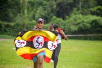 Man Running Holding an Uganda Flag