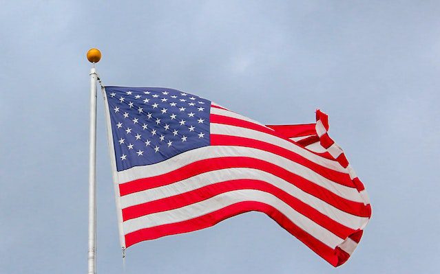 Usa Flag Waving On White Metal Pole