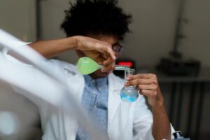 Man Mixing Chemicals In A Flask